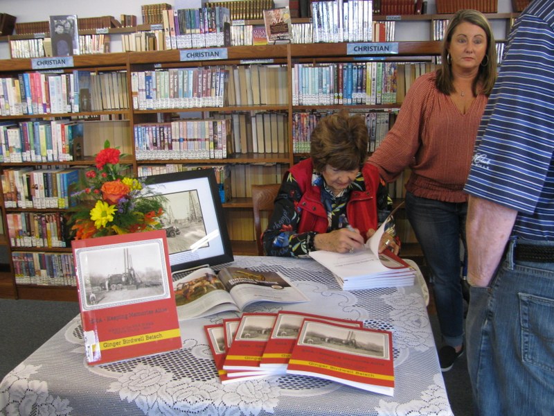 Ginger Beisch signing her book.JPG